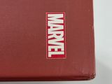 someone is holding a red box with the word marvel on it