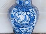a blue and white vase sitting on top of a table