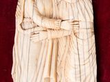 an image of a carving of a woman holding a child