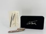 the pen is sitting next to a box with a pen in it