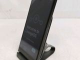 a phone that is sitting on a stand on a table