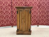 a small wooden cabinet in the corner of a room