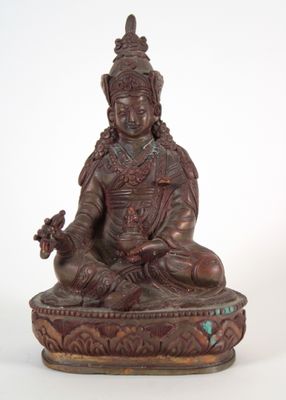 an antique bronze statue of a woman sitting in a lotus position