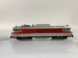 two toy trains on a white surface with a white background