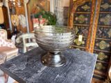 a glass bowl sitting on top of a wooden table