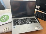 a laptop computer sitting on a desk next to a keyboard