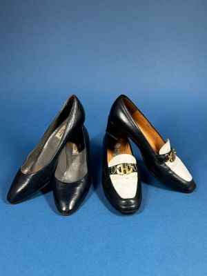two pairs of black and white shoes on a blue surface