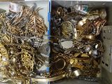 a box full of gold and silver jewelry on a table