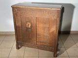 an old wooden cabinet with a door on it