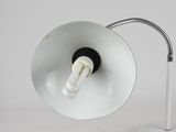 a white lamp that is on a white table