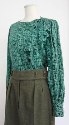 green blouse with ruffles and buttons on a mannequin mannequin mannequin mannequin mannequin mannequin mannequin mann