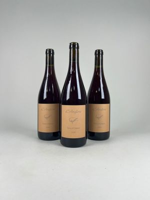 three bottles of wine sitting next to each other on a table