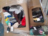 a cardboard box filled with clothes and other items