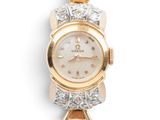a close up of a gold and diamond watch on a white background