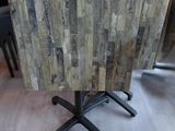 a small table with a wooden top on a wooden floor