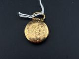 a close up of a gold locke on a black surface
