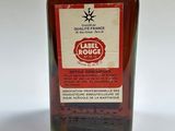 an image of a bottle of liquor sitting on top of a table