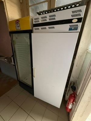 un réfrigérateur et un congélateur dans une pièce au sol carrelé