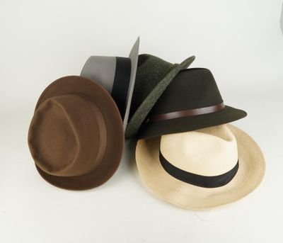 three hats are stacked on top of each other on a white surface