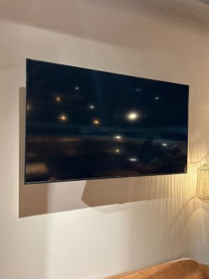 a large flat screen tv mounted on the wall in a living room