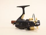 a close up of a spinning reel on a white surface