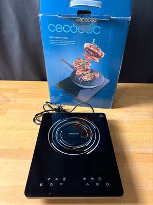 a black electric cooktop sitting on top of a wooden table