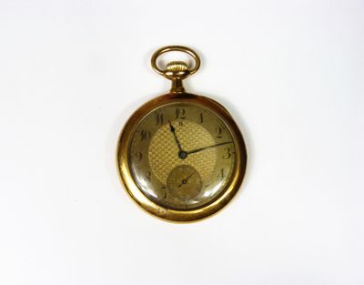 an old pocket watch on a white surface with a white background