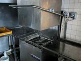 a kitchen with a stove, sink, and refrigerator in it