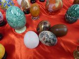many different colored eggs on a red table cloth