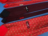 four ties are lined up in a row on a blue surface