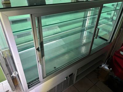 a glass display case in the middle of a room
