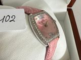 a pink watch in a box with a price tag on it