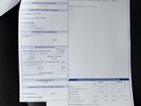 two papers that are sitting on the seat of a car