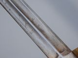 a close up of a gold and silver sword