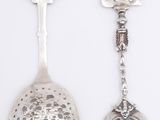 two spoons that are next to each other on a table