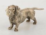 silver dog figurine on a white background