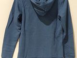 a blue sweatshirt with a hoodie hanging on a hanger