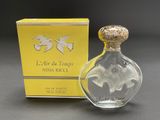 an image of a bottle of perfume with a box in the background