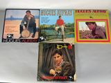 three elvis presley album covers on a white table top