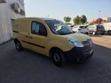 the yellow van is parked in the parking lot outside of a building