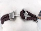 a brown leather bracelet with a silver anchor on it