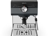 a close up of a coffee machine on a white surface