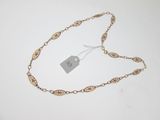 a close up of a gold chain with a price tag on it