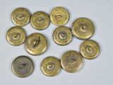 several brass buttons are arranged in a circle on a white surface