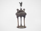 a statue of a bird sitting on top of a vase