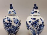 pair of blue and white vases with flowers and birds on them
