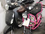 two mopeds parked next to each other in a garage
