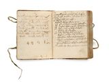 an open book with writing on it sitting on top of a table