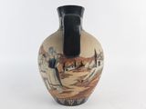 a black and white vase with a painting on it