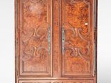 an old wooden armoire with carvings on the doors and drawers